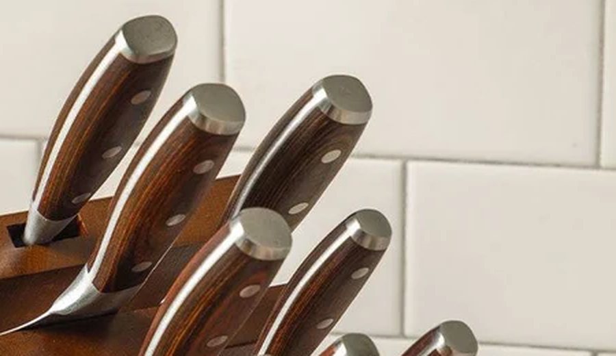 Close-up of wood-handled kitchen knives in a knife block